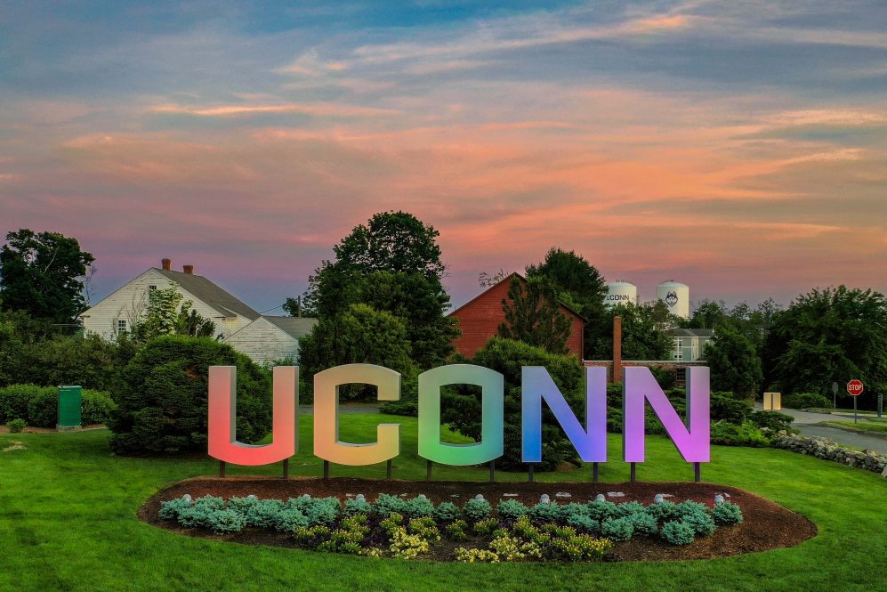 The UConn gateway sign lit in rainbow colors in observance of LGBTQIA+ pride month.