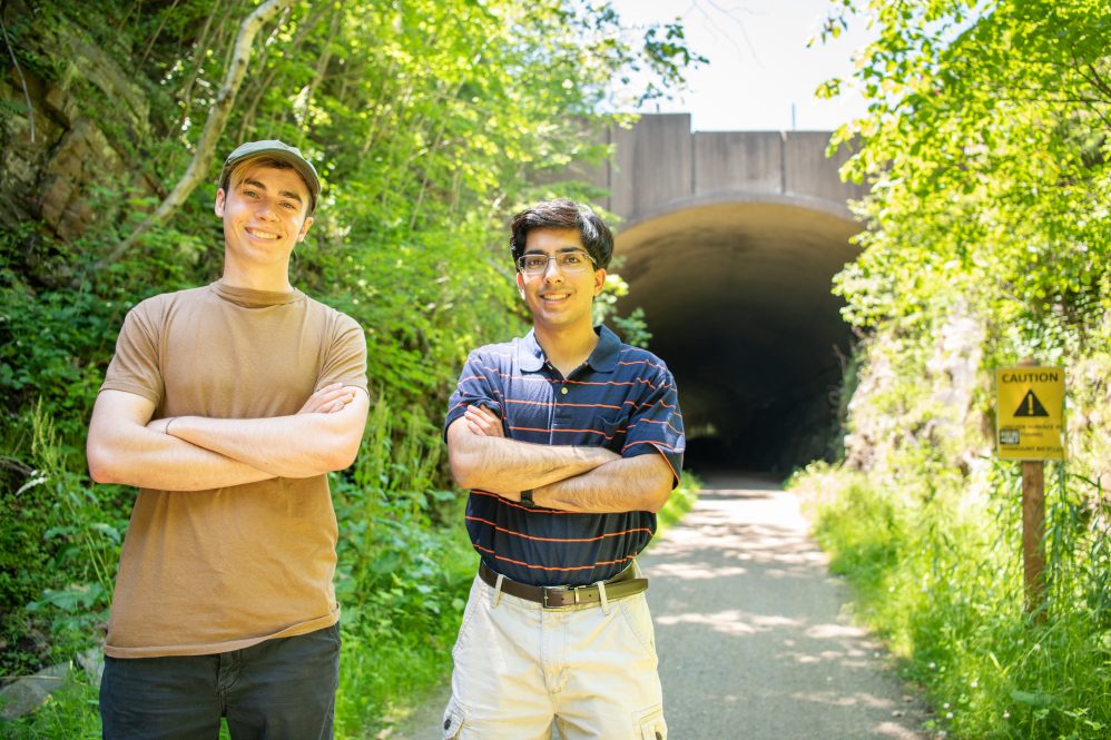 UConn students Robert Avena (left) and Sumeet Kadian (right) pose for a photo in front of the Hop River Trail tunnel in Bolton Notch State Park that runs under Interstate 384 in Bolton, CT