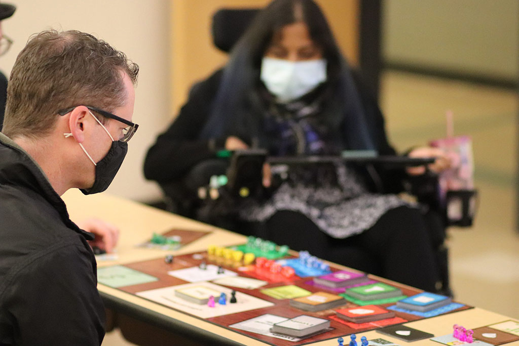 Two individuals looking at a game board.