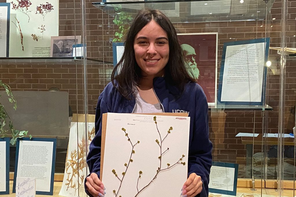 Michelle Hernandez holding the mounted spicebush specimen