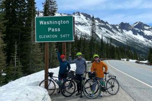 Cyclists at Washington Pass sign