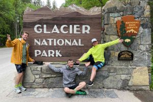 Cyclists at Glacier National Park sign