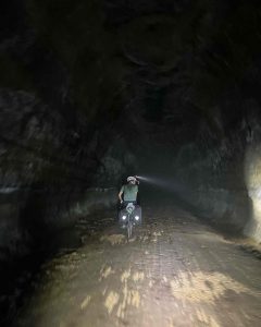 Cyclist in unlit tunnel