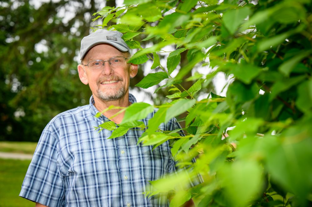 Mark Brand, professor of horticulture, stands with a descendent of the beloved "swing tree" growing along Swan Lake