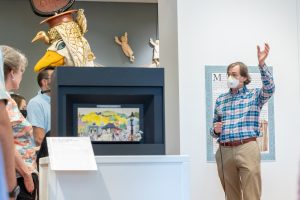 John Bell, museum director of the Ballard Institute and Museum of Puppetry in Storrs, gives a tour around the â€œSwing into Action: Maurice Sendak and the World of Puppetryâ€ exhibition on display at the museum on July 7, 2022. (Sydney Herdle/UConn Photo).