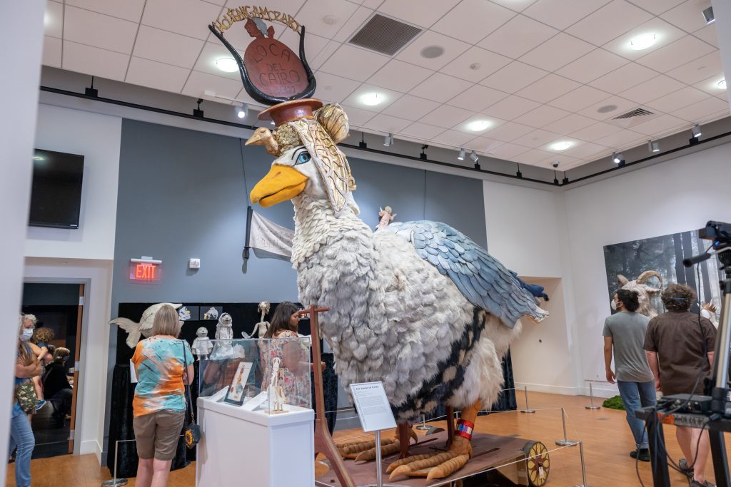 The "Goose of Cairo" sits prominently among the work on display in the 'Swing into Action: Maurice Sendak and the World of Puppetry' exhibition at the Ballard Institute and Museum of Puppetry in Storrs as attendees walk around the exhibition during the opening event on July 7, 2022.