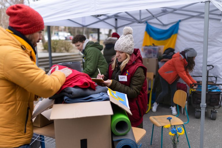 The volunteers distributing donations to refugees on the Ukrainian border, Russian-Ukrainian war concept.