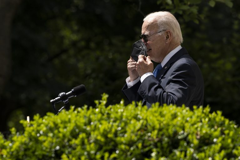 President Joe Biden takes off a mask as he enters the Rose Garden to deliver remarks on COVID-19 at the White House on July 27, 2022 in Washington, D.C.