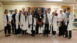 A group of UConn volunteers, in white coats, after administering doses of the COVID-19 vaccine.