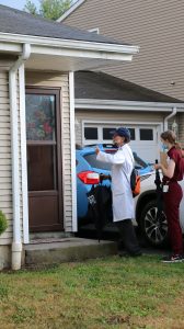 Volunteers knocking on doors in Hartford to administer doses of the COVID-19 vaccine.