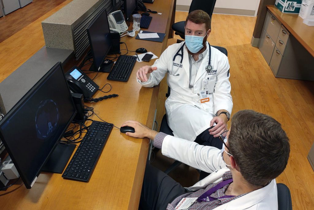 Two doctors in discussion on hospital floor