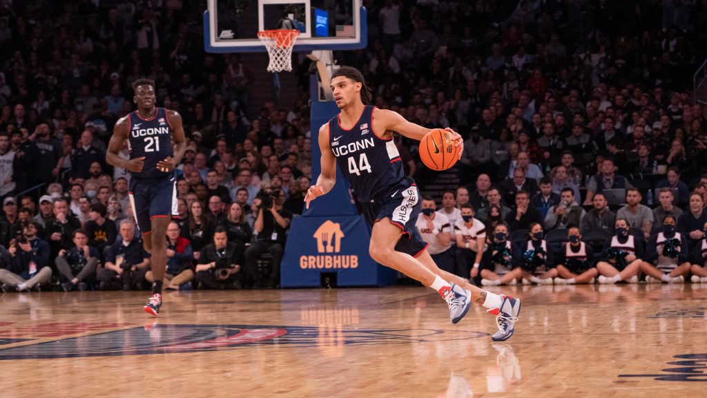 UConn Men's Basketball players on the court during a game