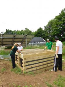 Students and volunteers constructing the crib portion of the composting privy. 