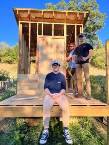 Students pose in front of the composting privy. Construction will be completed in the near future. 