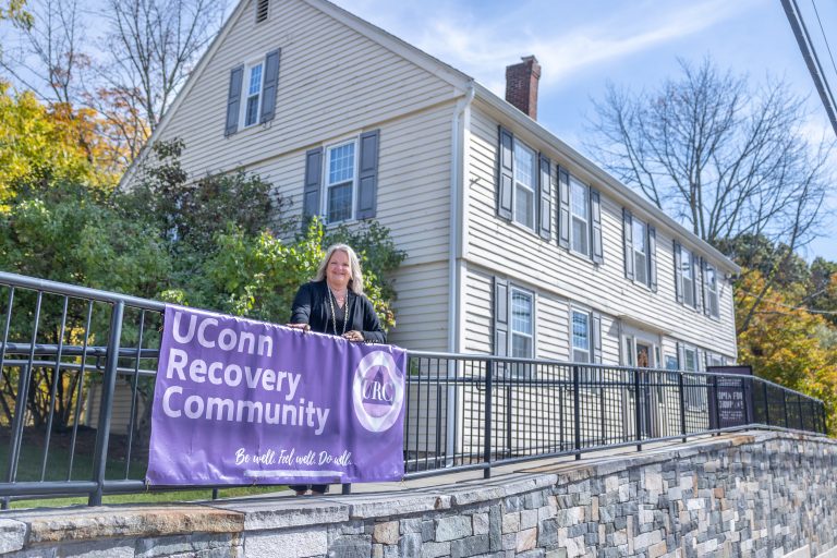Sandy Valentine, health promotion manager for the division of Student Health and Wellness, stands outside the UConn Recovery Community’s current home in the Cordial Storrs House on Oct. 12, 2022.