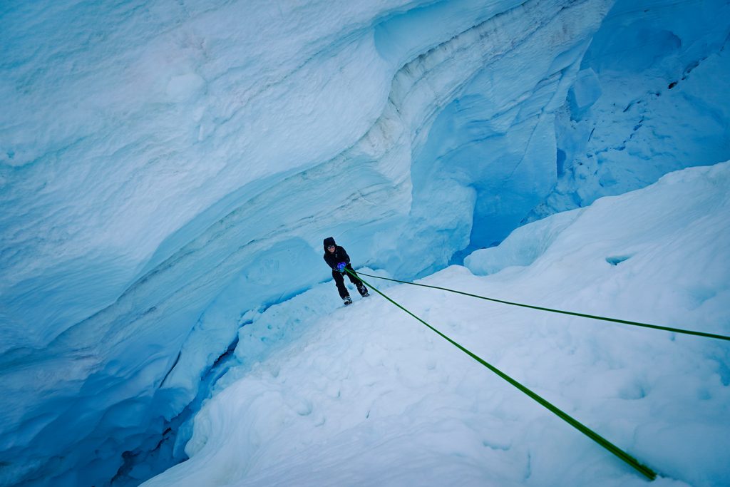 Student climbs up glacier in Juneau Icefield.