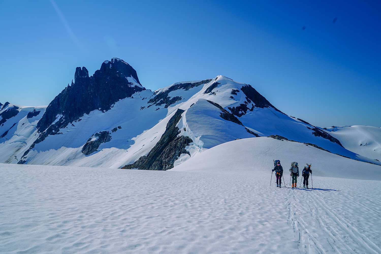 Three students hike in snow in Juneau Icefield.