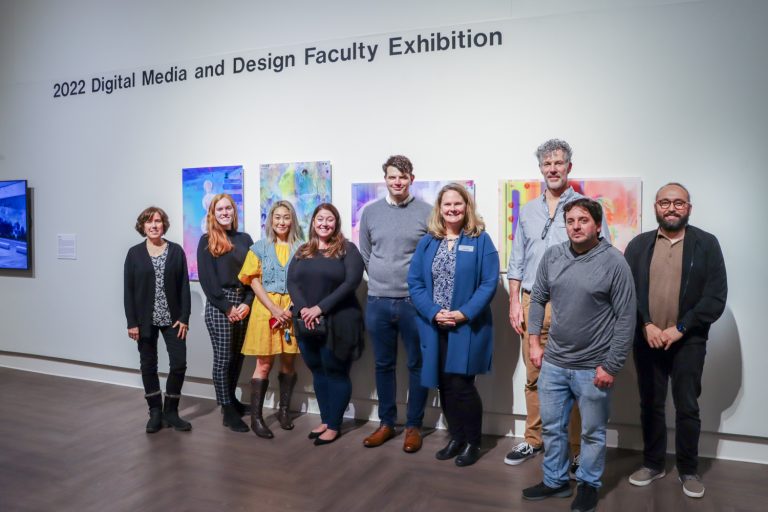Catherine Masud, Laurel Pehmoeller, Heejoo Kim, Sam Olschan, James Coltrain, Heather Elliott-Famularo, Kerry Smith, Michael Toomey, and Tanju Özdemir pose for a photo during the 2022 Digital Media and Design Faculty Exhibition opening reception at the William Benton Museum of Art