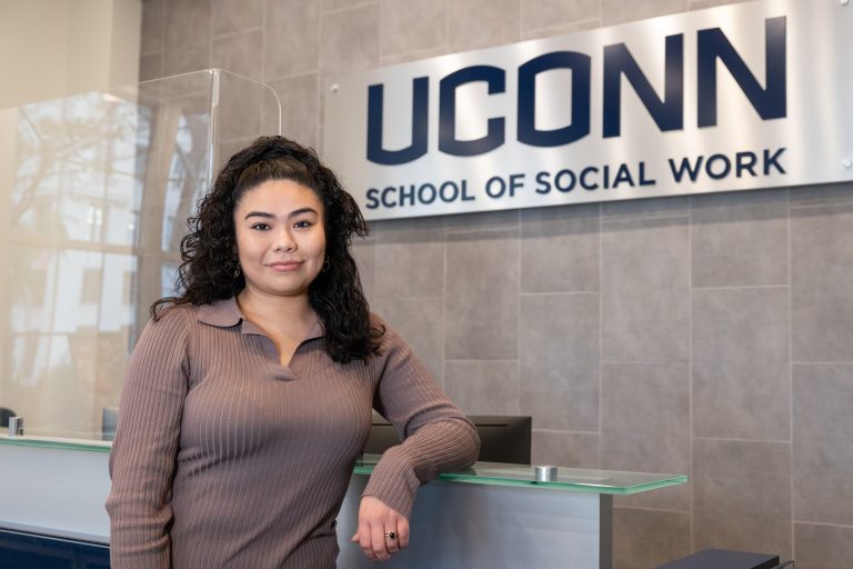 Kelly Sanchez, a third-year master’s student at the UConn School of Social Work, poses for a photo in the School of Social Work Building at UConn Hartford