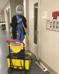 Kayla Cunningham cleaning the floor in the operating room area