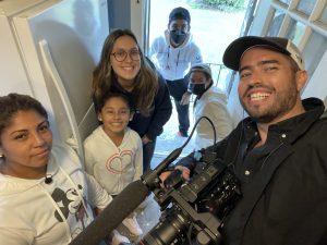 Guerra (right) with Genesis and members of his production team, including Syracuse University students Adriana Rozas Rivera and Maranie Staab and UConn alum Jonathan Iturriaga-Dasilva '21 (SFA).