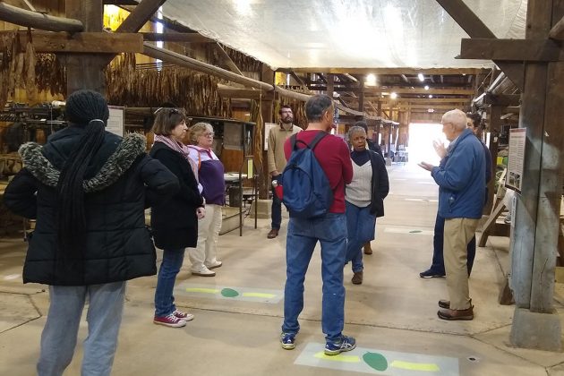 Teachers gather in barn to learn about shade tobacco industry.
