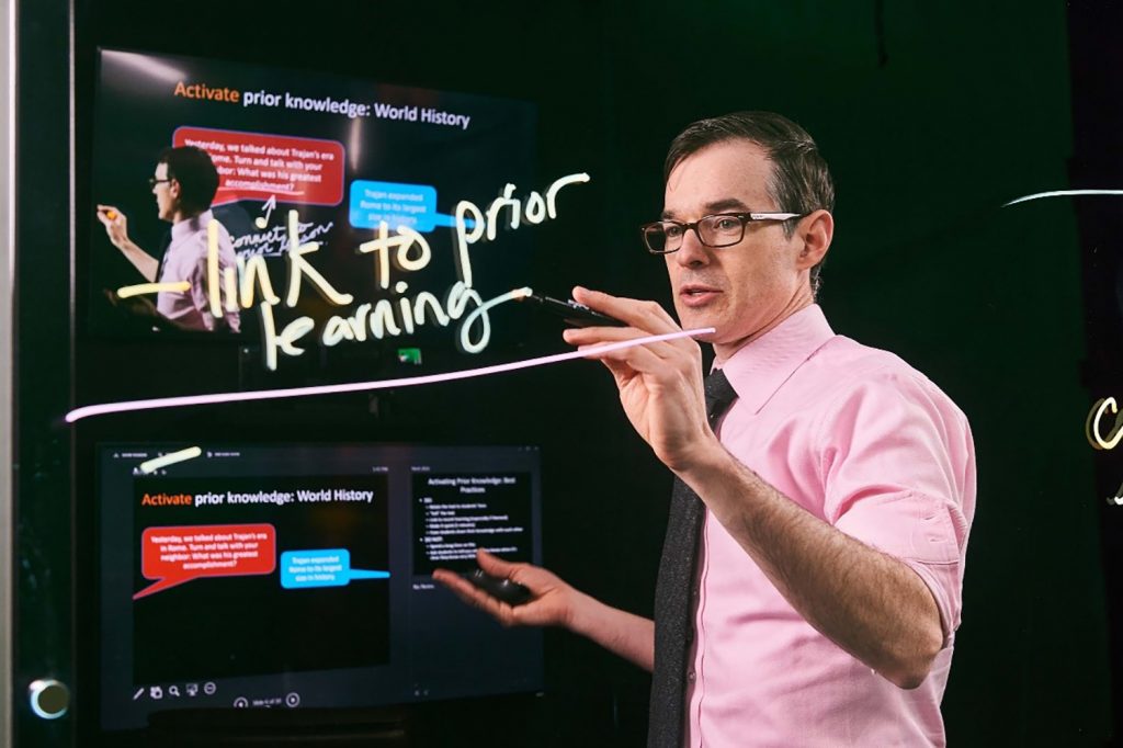 Devin M. Kearns uses a lightboard during a lecture