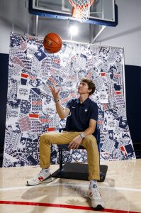 Jared Beltz '23 (SFA) poses for a photograph during a media day event he organized recently for the UConn men's and women's basketball teams through a partnership between the Digital Media & Design and Athletics departments.