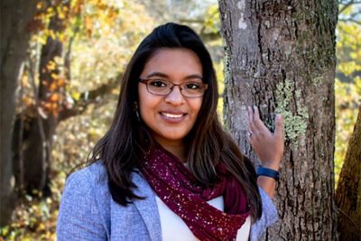 Sandra Silva-Enos stands outdoors.