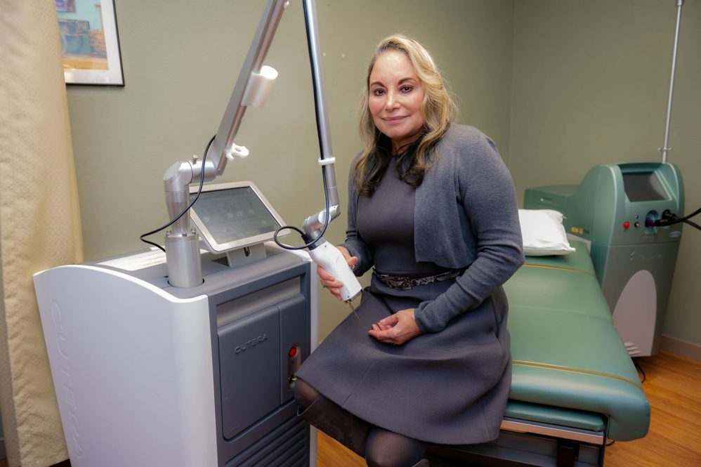 Dr. Maritza Perez with laser machine in dermatology exam room