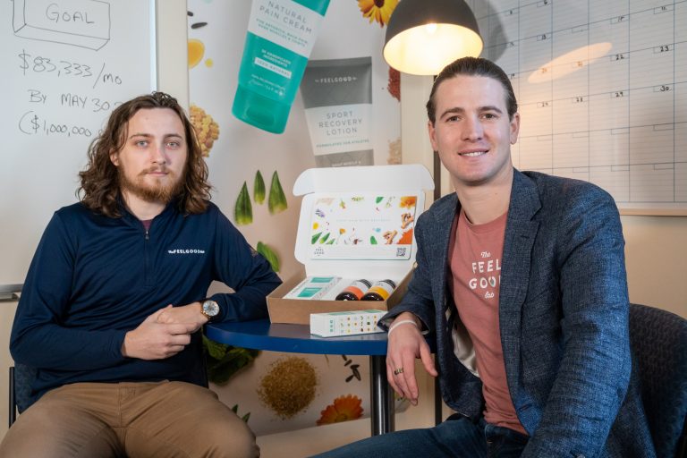 Devin McNamara ’21 (CLAS), left, and Ryan Gresh ’09 (ENG) pose for a photo in The Feel Good Lab’s office in UConn Farmington’s Technology Incubation Program building
