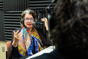 Board of Trustees Distinguished Professor of English Gina Barreca sits in recording studio.