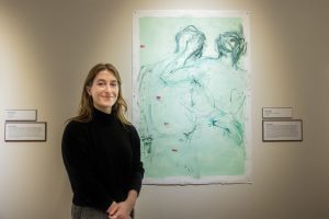 Anna Schwartz ’25 poses next to her painting “Projective Verse 