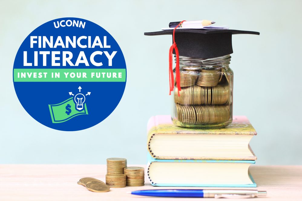 A jar of coins with a graduation cap on it sits on a stack of textbooks, next to the logo for UConn Financial Literacy Week.