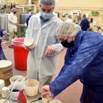 Dennis D'Amico, professor of animal science, works with students to create ice cream at the UConn Creamery. (Jason Sheldon/UConn Photo)