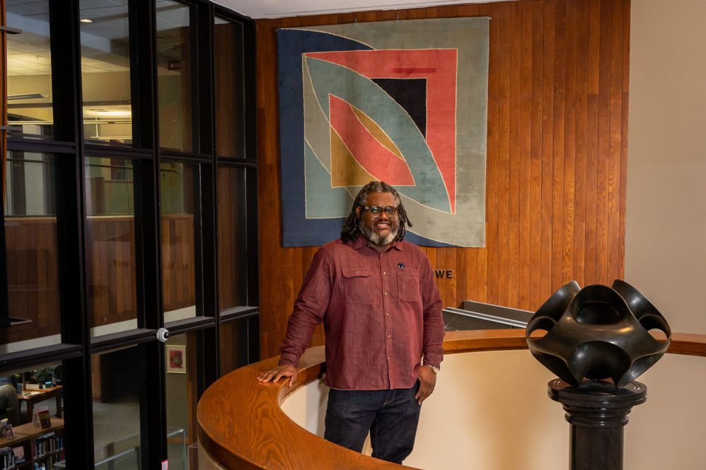 Andre Rochester next to and in front of artwork