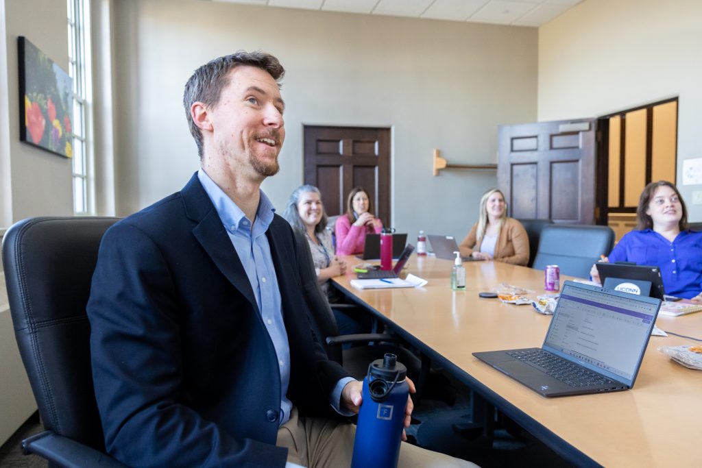 One Stop Student Services director Michael Ormsby leads a meeting with other members of the UConn Enrollment Planning and Management team on March 10, 2023.