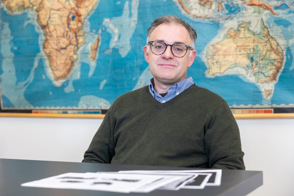 UConn professor of anthropology Christian Tryon poses for a photo in his lab in Beach Hall