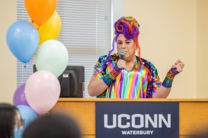 Drag queen activist Mucha Mucha Placer speaks at UConn Waterbury’s inaugural Pride Party celebrating the LGBTQIA+ community on March 28, 2023.