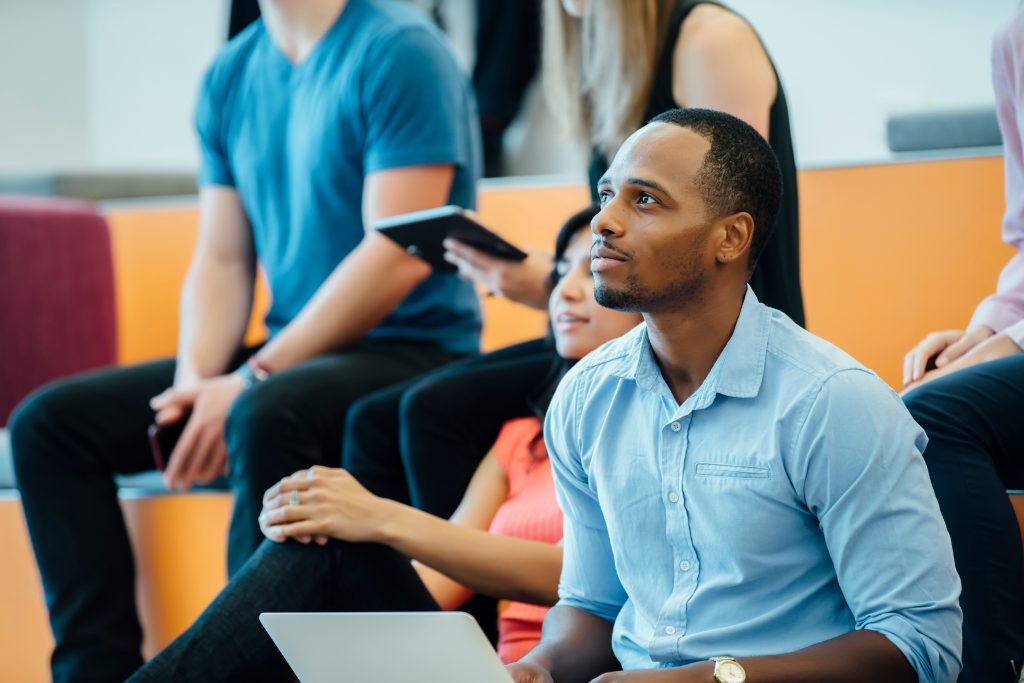 Group of people enjoying a lecture in a modern auditorium.