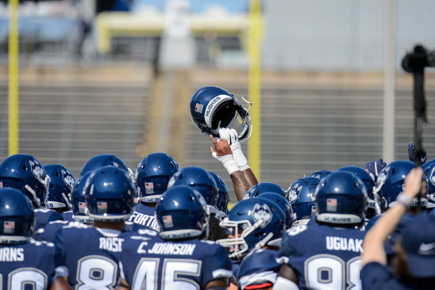 Members of the UConn football team cheer before the start of the game against Holy Cross at Pratt & Whitney Stadium at Rentchler Field on Sept. 4, 2021.