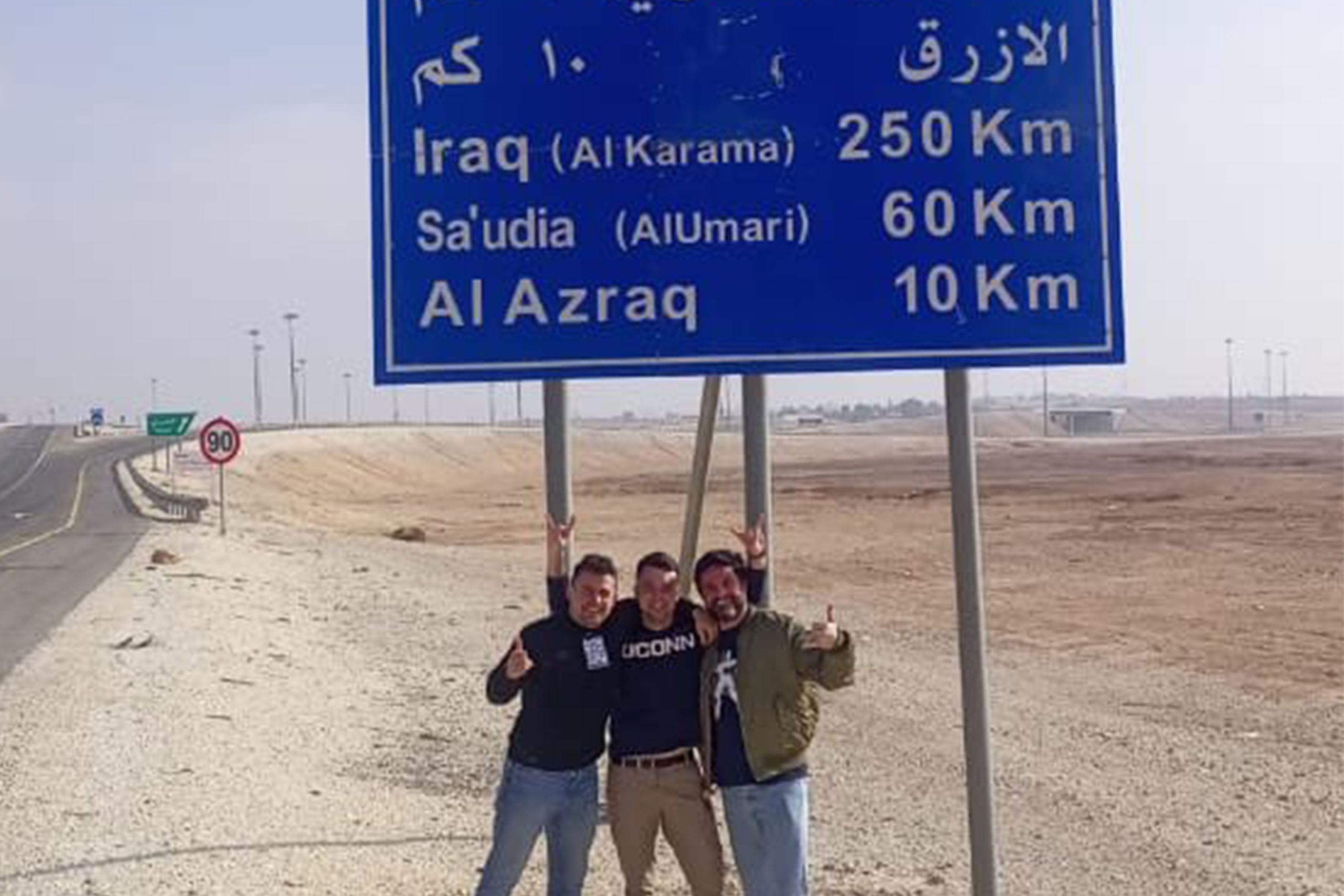 Ryan Coles, Peter Goggins, and David Coles (Ryan’s brother) on a desert highway in Jordan – much of their work was proximal to Syria and Iraq.
