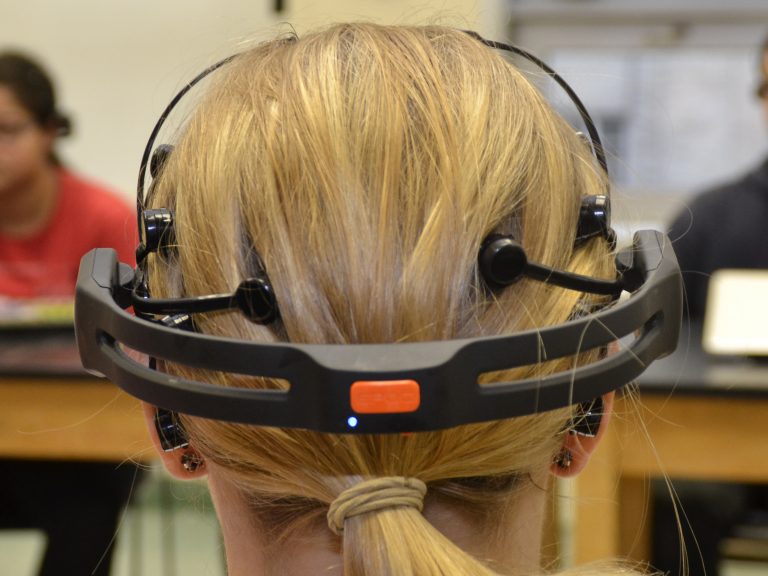 Back of head with EEG on student in a classroom.