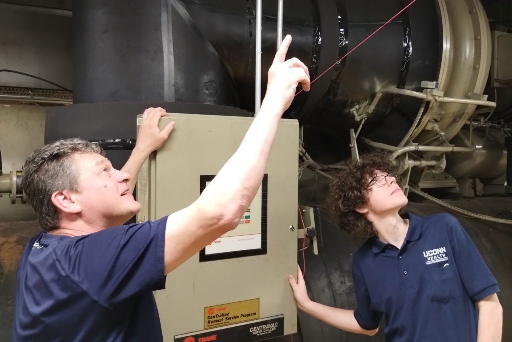 Apprentice with mentor pointing to ceiling