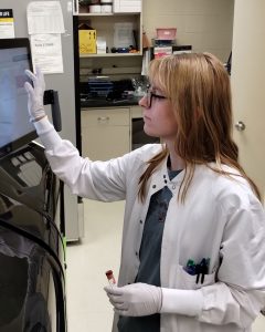 medical technologist using a touch screen in the lab
