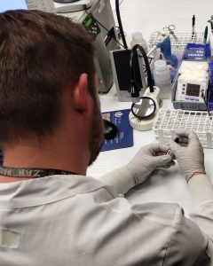 lab worker handling a blood specimen