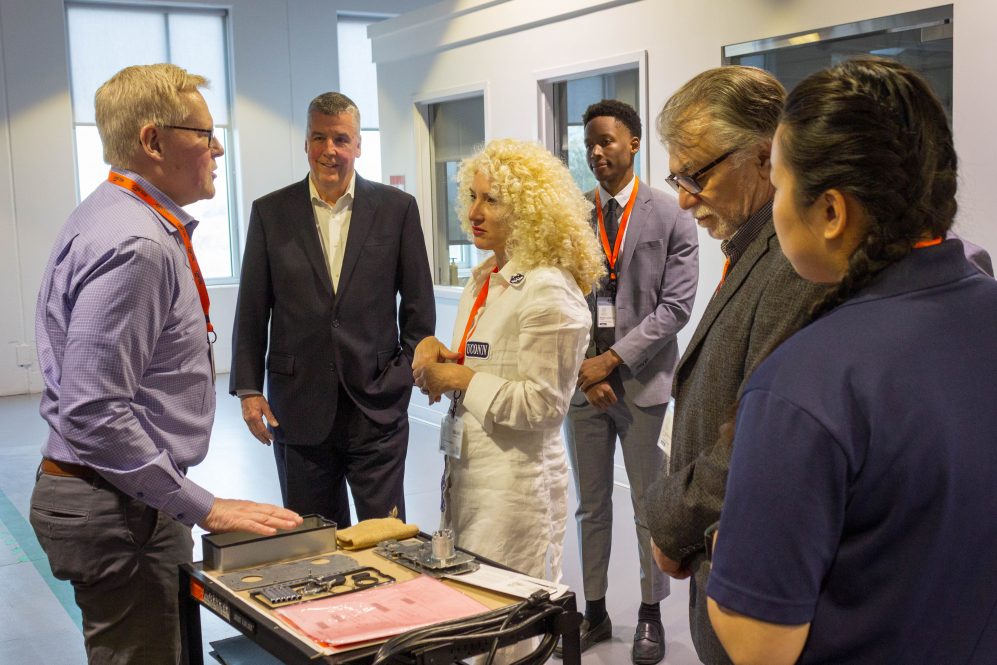 UConn President Radenka Maric and Rohan Anderson '25 talk with members of the Belimo team during an April visit to the company's Danbury facility.