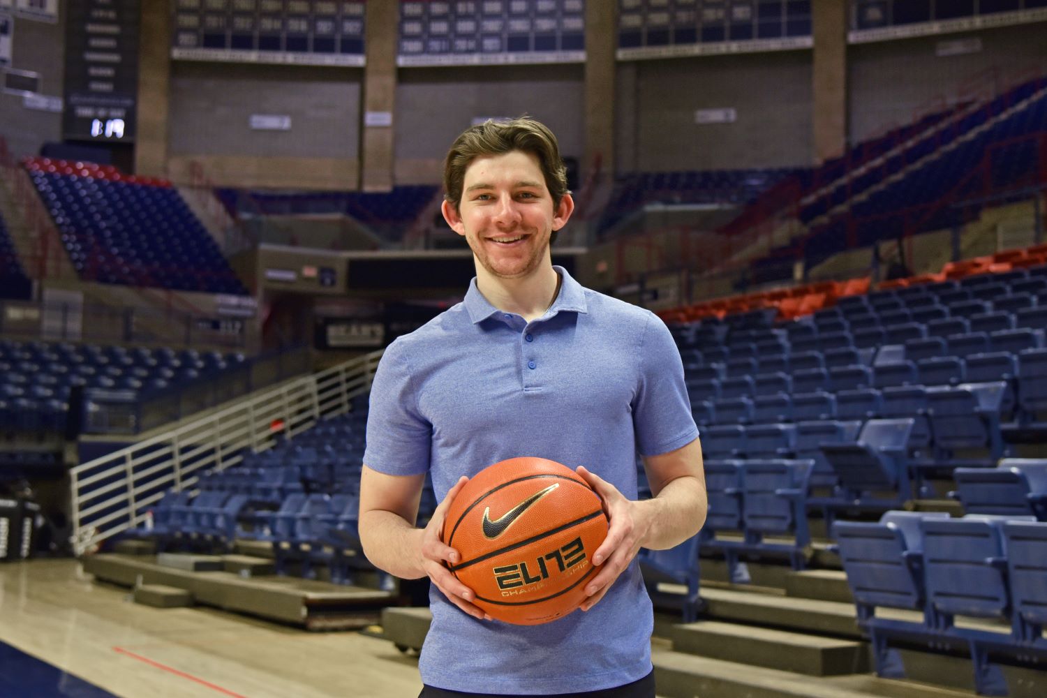 Francis Walsh ‘23 (CAHNR), a major in exercise science in the Department of Kinesiology in the College of Agriculture, Health and Natural Resources, poses for a portrait for Commencement 2023 inside Gampel Pavilion (GAMP). Apr. 11, 2023. (Jason Sheldon/UConn Photo)