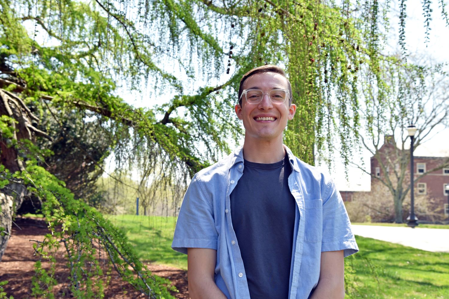 Nicolas Lombardo ‘23 (CAHNR), a major in natural resources in the Department of Agricultural and Resource Economics in the College of Agriculture, Health and Natural Resources, poses for a portrait for Commencement 2023 outside the Wilfred B. Young Building (YNG). Apr. 21, 2023. (Jason Sheldon/UConn Photo)