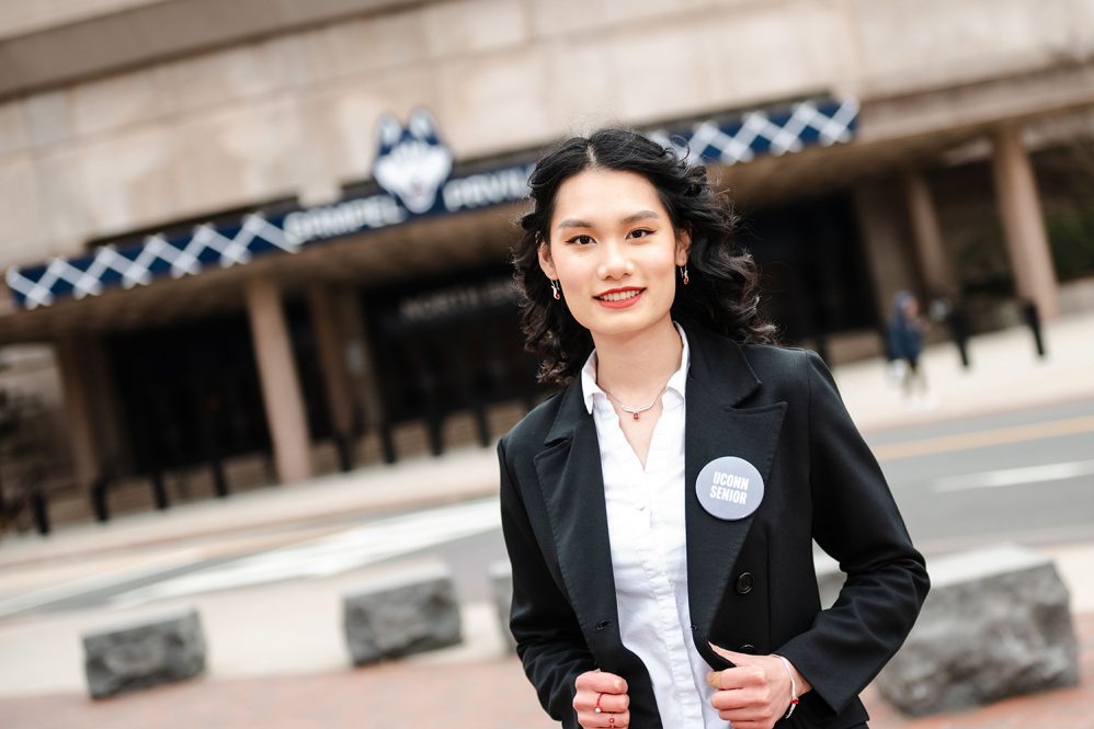 Esther Nguyen '23, standing in front of Gampel Pavilion. Esther will be the undergraduate student speak at Commencment on May 6. (Nathan Oldham / UConn School of Business)